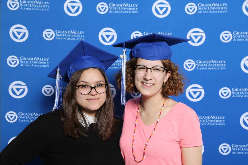 Two friends smile for a photo together at Gradfest